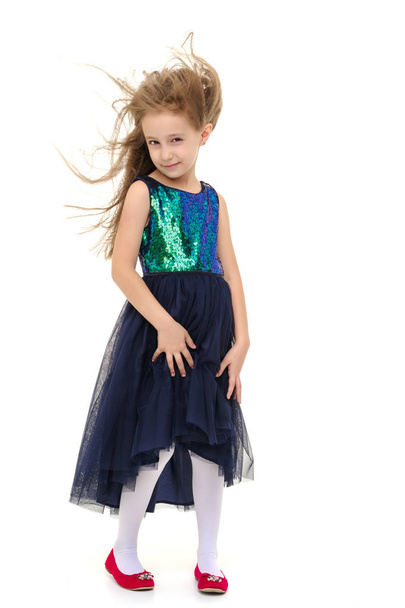 Little girl in a dress developing in the wind. - Фото, изображение
