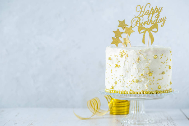 Golden birthday concept - cake, presents, decorations - 写真・画像