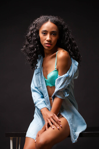 Sexy beautiful african american woman posing in blue shirt, Dark Studio shot. - Foto, Imagem