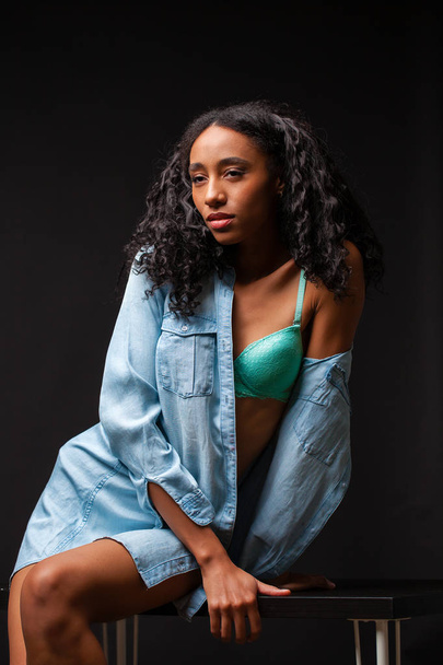 Sexy beautiful african american woman posing in blue shirt, Dark Studio shot. - Zdjęcie, obraz