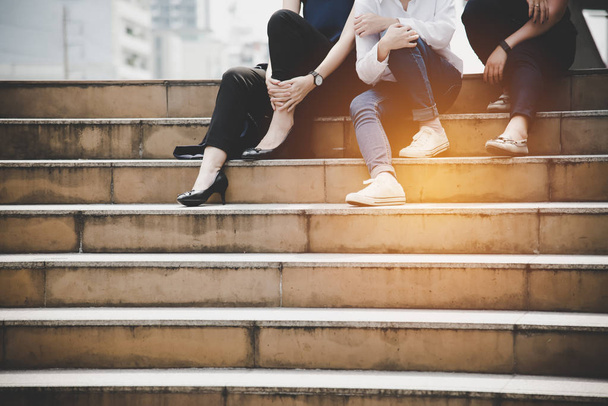 Close up lower legs of women friendship sitting and talking to each others at stair in outdoors. Relationship and Lifestyle concept. Business and Relax concept. City and Friend theme. - Foto, imagen