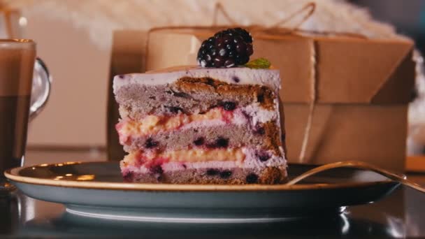A bakery. A sweet breakfast. A piece of blackberry cake and cup of coffee. Cake overview - Felvétel, videó