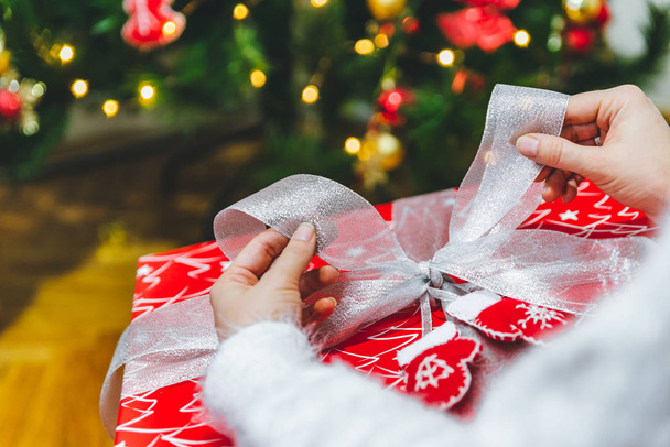 hand wrapping christmas present winter holidays - Valokuva, kuva