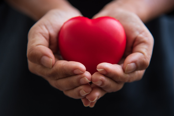 Close-up handen rood hart als hart donor te geven. De dag van de Valentijnskaart van liefde concept. Medische ventilator en hart donateur liefdadigheid. Ondertekenen van mededogen en gezond. Helpen hand in vrijheid leven donatie - Foto, afbeelding