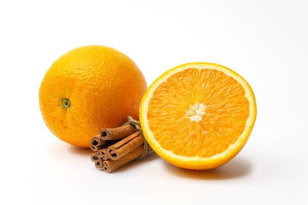 Verse sinaasappelen citrus en kaneel stokjes geïsoleerd - Foto, afbeelding