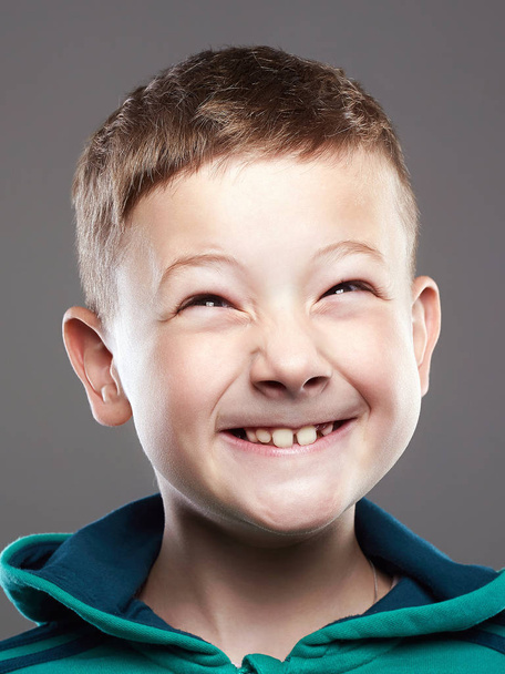 Funny kid. little smiling boy. grimace child. close up portrait - Photo, Image