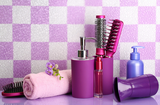 Hair brushes, hairdryer and cosmetic bottles in bathroo - Photo, Image
