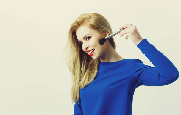 Girl applying makeup on face skin with powder brush - Fotografie, Obrázek