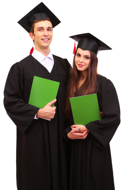 Two happy graduating students holding graduation certificate isolated on white - Фото, зображення