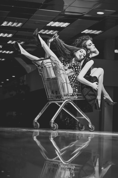 Shopping women sit in trolley cart - Φωτογραφία, εικόνα