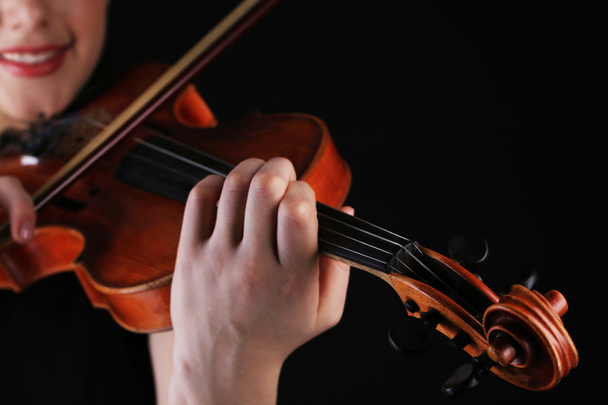 Musician playing violin on black background - Zdjęcie, obraz