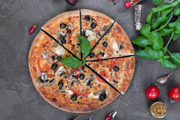 Pizza, food, vegetable, margarita.  Vegetables, mushrooms and tomatoes pizza on a black wooden background. It can be used as a background - Photo, image