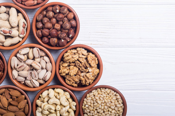 Mix of nuts : Pistachios, almonds , walnuts , pine nut , hazelnuts and cashew . Snack in bowl backgrond - Fotó, kép