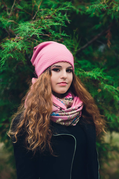 Portrait of funny young girl in the autumn weather in warm clothes and hat. - Fotografie, Obrázek