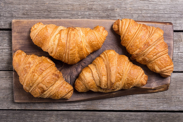 French delicious breakfast . Croissants on wooden background - Foto, Imagem