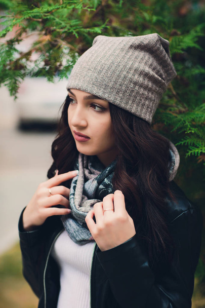 Portrait of funny young girl in the autumn weather in warm clothes and hat. - Photo, image