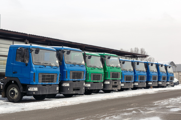 Kış açık havada otopark Bayilik yeni orta boy kamyonlara. Kamyon servis ve bakım. Teslim ve depo hizmeti. - Fotoğraf, Görsel
