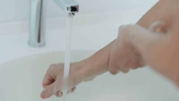 Surgeons washing their hands with masks in a surgical washroom - Filmmaterial, Video