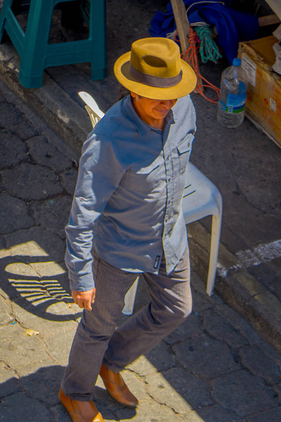 OTAVALO, ECUADOR, NOVEMBER 06, 2018 Above view of unidentified indigenous man walking in the streets of the city of Cotacachi - Fotografie, Obrázek