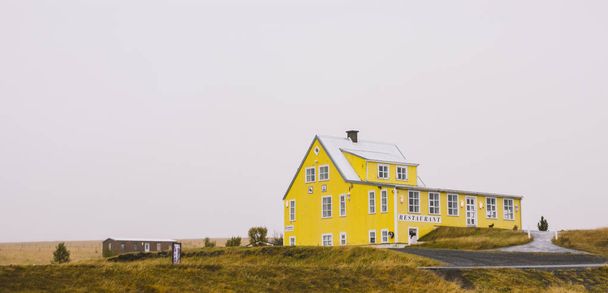 Village avec fermes dans une zone rurale des montagnes d'Islande, avec des montagnes enneigées en arrière-plan
. - Photo, image