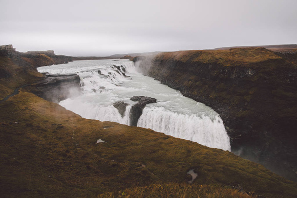 Panoramic photos of famous Icelandic waterfalls on cloudy days with geological formations. - Photo, Image