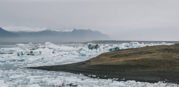 Huge blocks of ice on Glacial river and blue icebergs on Jokulsarlon glacier lake. Vatnajokull National Park, Iceland. - Zdjęcie, obraz