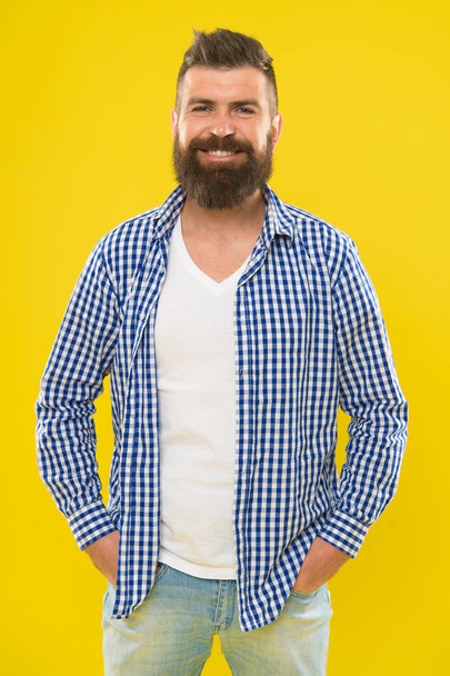 Bearded and happy. Hipster appearance. Beard fashion and barber concept. Man bearded rustic hipster stylish beard yellow background. Barber tips maintain beard. Stylish beard and mustache care - Photo, image