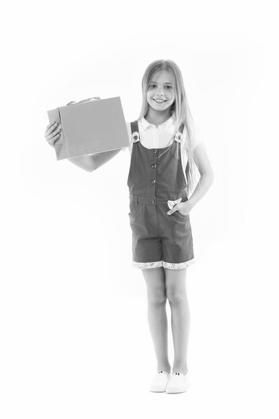 Happy girl hold paperbag isolated on white. Little shopaholic smile with shopping bag. Child shopper smiling with paper bag. Black Friday and sale. I made my choice, copy space - Foto, immagini