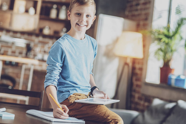 Positive delighted kid doing homework - Foto, Imagem