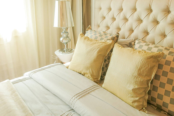 Pillows on bed and lamp in bedroom - Photo, image