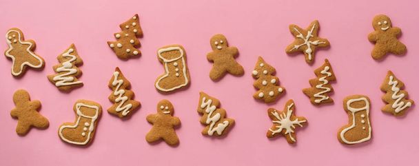 Christmas gingerbread cookies on pink background. Banner. Top view, copy space. New year concept. - Zdjęcie, obraz
