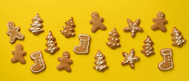 Christmas gingerbread cookies on yellow background. Banner. Top view, copy space. New year concept. - Zdjęcie, obraz