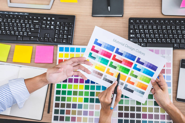 Young creative team having a meeting in creative office, Architectural drawing with work tools and accessories, Color swatch samples chart for selection coloring. - Photo, Image