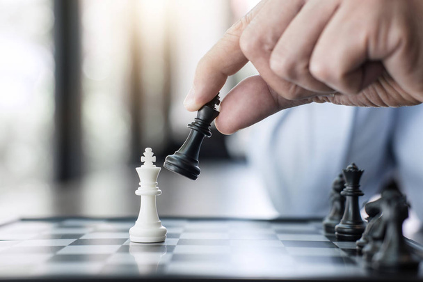 Businessman's hand playing chess game to development analysis new strategy plan, business strategy leader and teamwork concept for win and success. - Foto, immagini