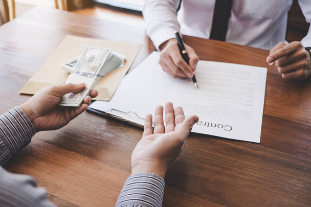 Business Signing a Contract Buy - sell house, Man sign a home insurance policy on home loans, insurance agent analyzing about home investment loan Real Estate concept. - 写真・画像