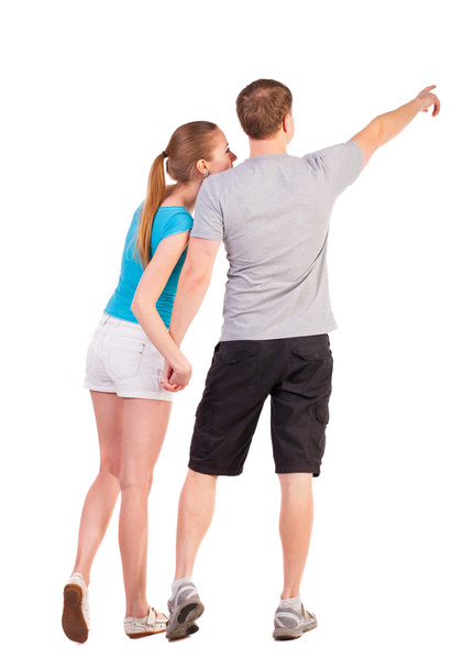 Back view of young couple pointing at wall - Fotografie, Obrázek