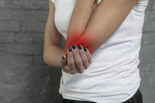 woman shows that her elbow hurts - Фото, зображення