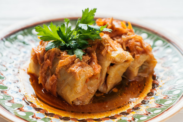 close up of traditional stuffed cabbage rolls on plate with ornament - Фото, изображение