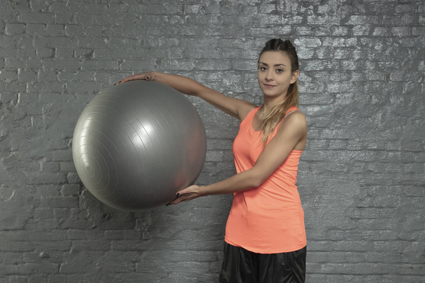 young athletic woman holding a ball - Valokuva, kuva