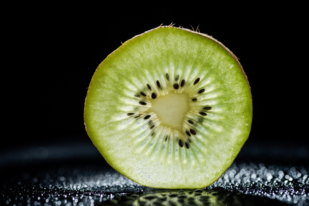 slice of kiwi fruit on black background - Фото, зображення