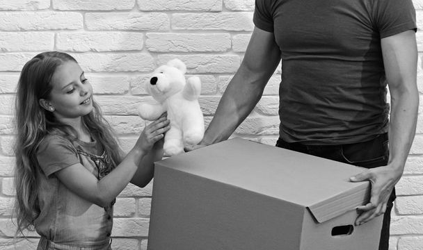 Dad and daughter hold cardboard box. Moving in or out - Foto, Imagen