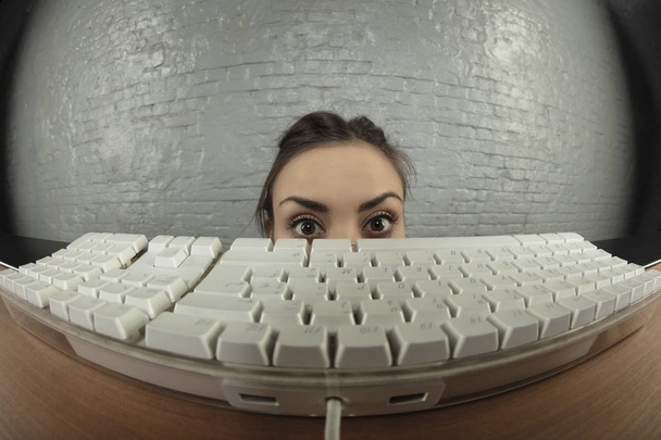 scared business woman hides under a desk - Foto, Imagem