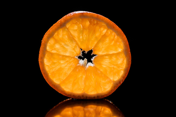 slice of fresh ripe orange isolated on black - Photo, Image