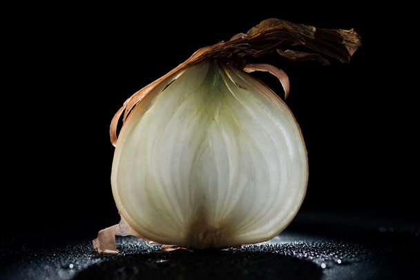slice of raw onion with water drops on black background - Photo, Image