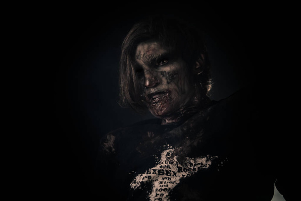 Scary zombie man posing against dark background - Foto, Bild