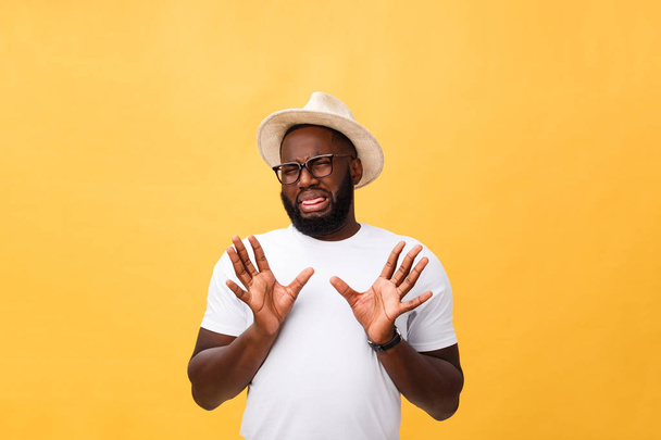 Closeup portrait of shocked mad young man raising hand up to say no stop right there, isolated on yellow background. Negative emotion facial expression feelings, signs symbols, body language. - Photo, Image