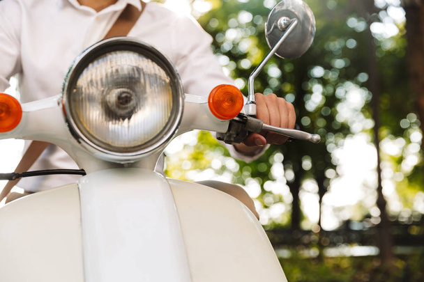 Cropped image of a young businessman sitting on a motorbike outdoors - Foto, Imagen