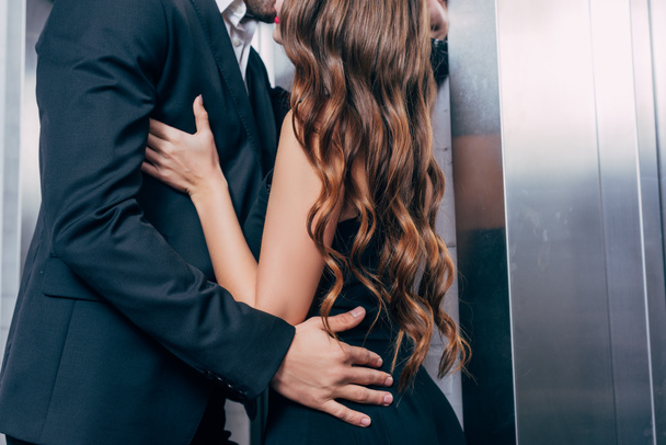 vue recadrée du couple s'embrassant passionnément près de l'ascenseur
 - Photo, image