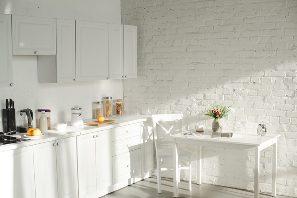 sunlight in white modern kitchen with cooking utensils - Photo, Image