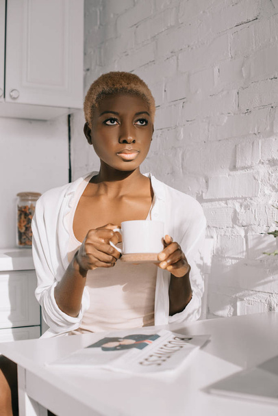 confident african american woman with short hair holding cup  - Photo, Image
